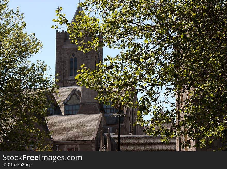 Scenic view of Christ Church cathedral with leafy trees in foreground, Dublin city, Ireland. Scenic view of Christ Church cathedral with leafy trees in foreground, Dublin city, Ireland.