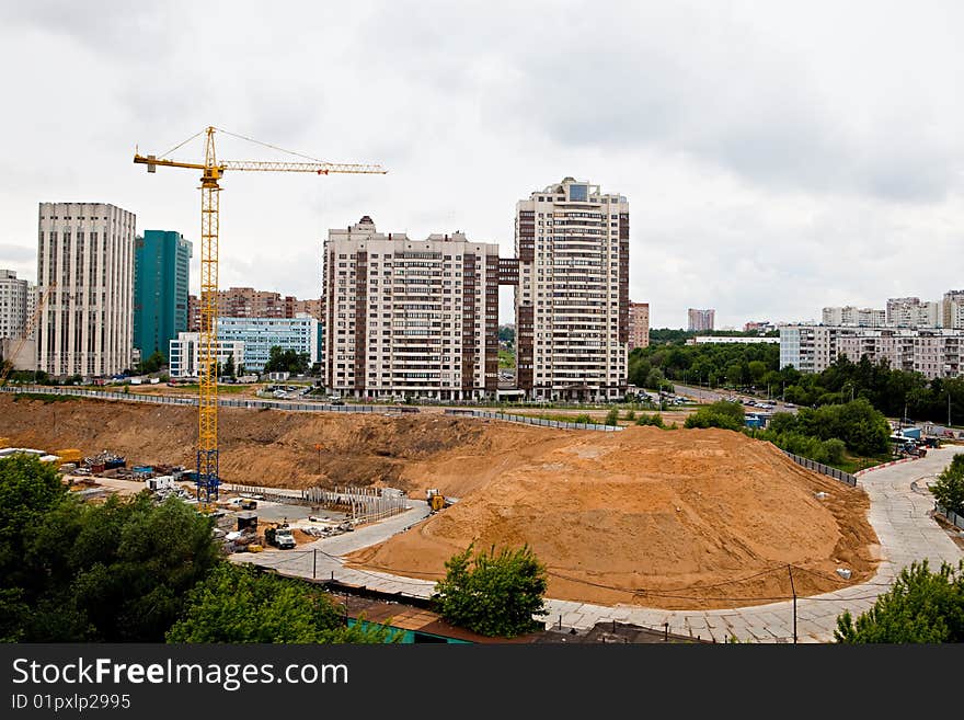 Building site with technics and the elevating crane