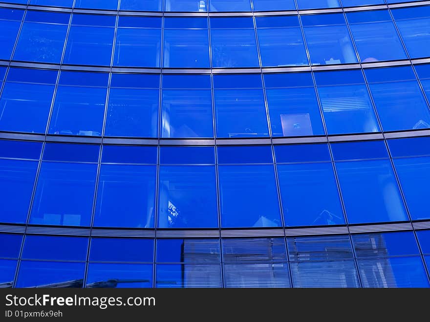 The blue background of the office building with windows. The blue background of the office building with windows