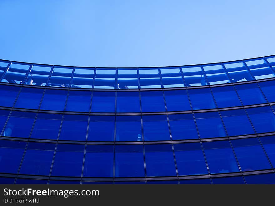 The blue background of the office building with windows. The blue background of the office building with windows