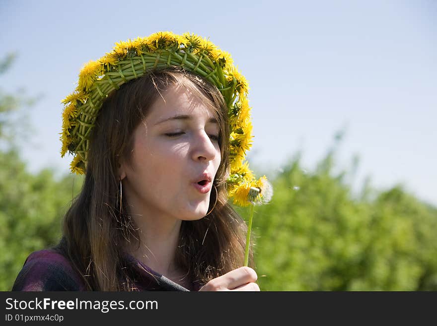 Girl blowing a dandelion