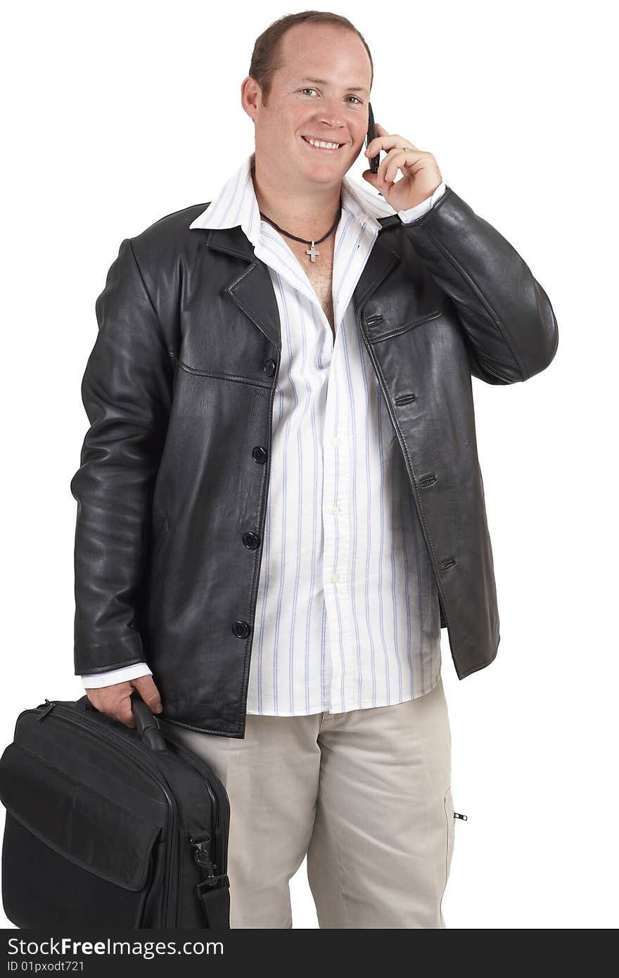 Young successful businessman wearing leather jacket talking on a cellphone and smiling. Isolated on white background. Young successful businessman wearing leather jacket talking on a cellphone and smiling. Isolated on white background