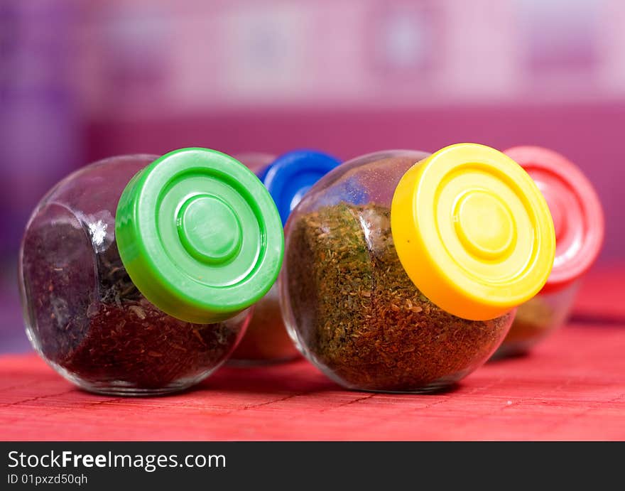 Four glass jars with spices and color covers