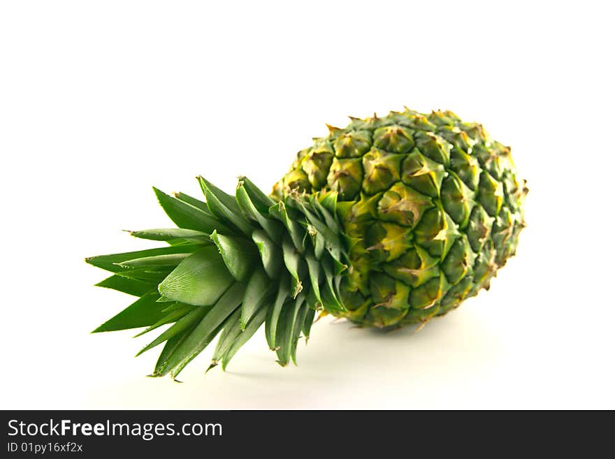 Fresh delicious looking green pineapple fruit on a white background with a clipping path. Fresh delicious looking green pineapple fruit on a white background with a clipping path