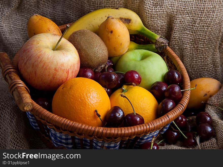 An assortment of fresh mixed fruits in a basket