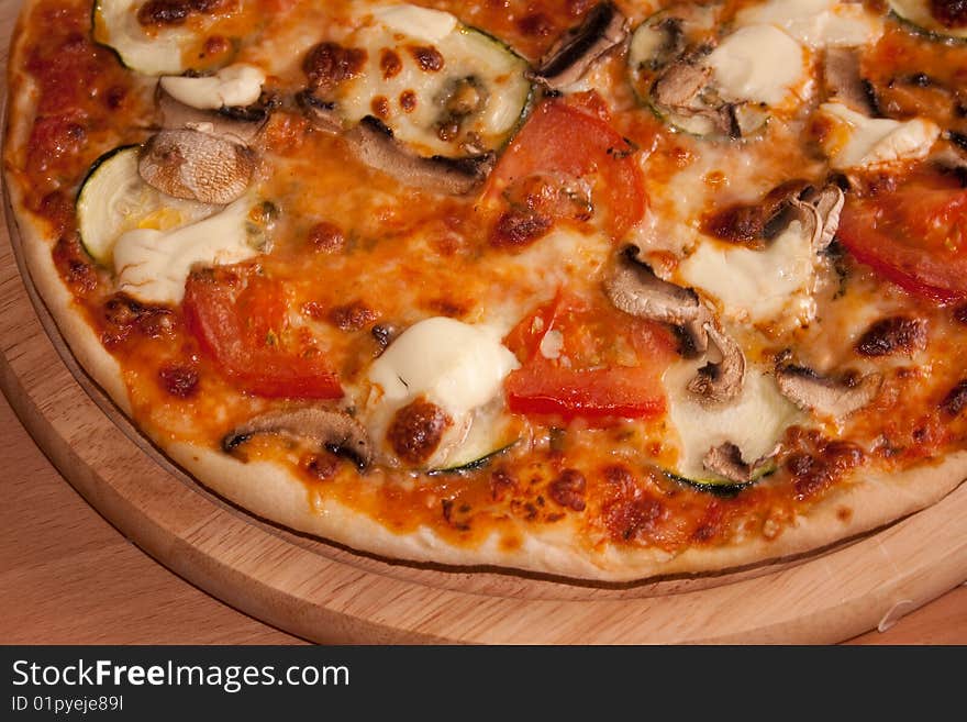 Freshly baked pizza from the furnace with vegetables. Freshly baked pizza from the furnace with vegetables