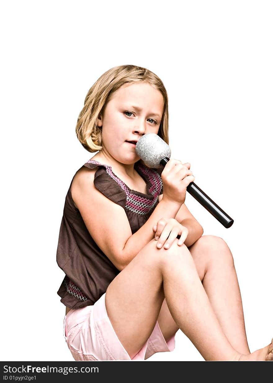 Young girl singing, isolated on white background. She's a wanna be, that is. Young girl singing, isolated on white background. She's a wanna be, that is.