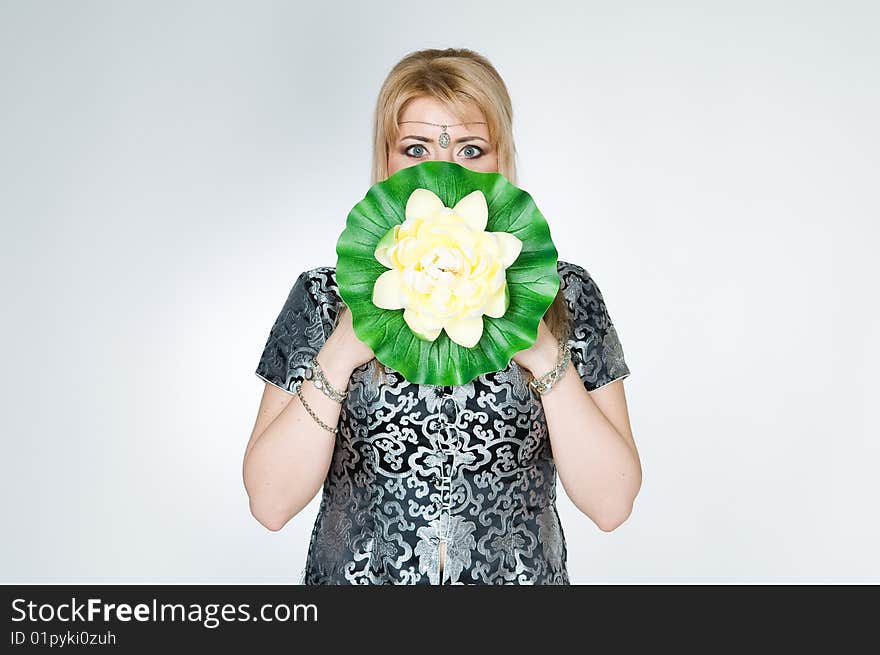 Beautiful woman with lotus flower, studio shot