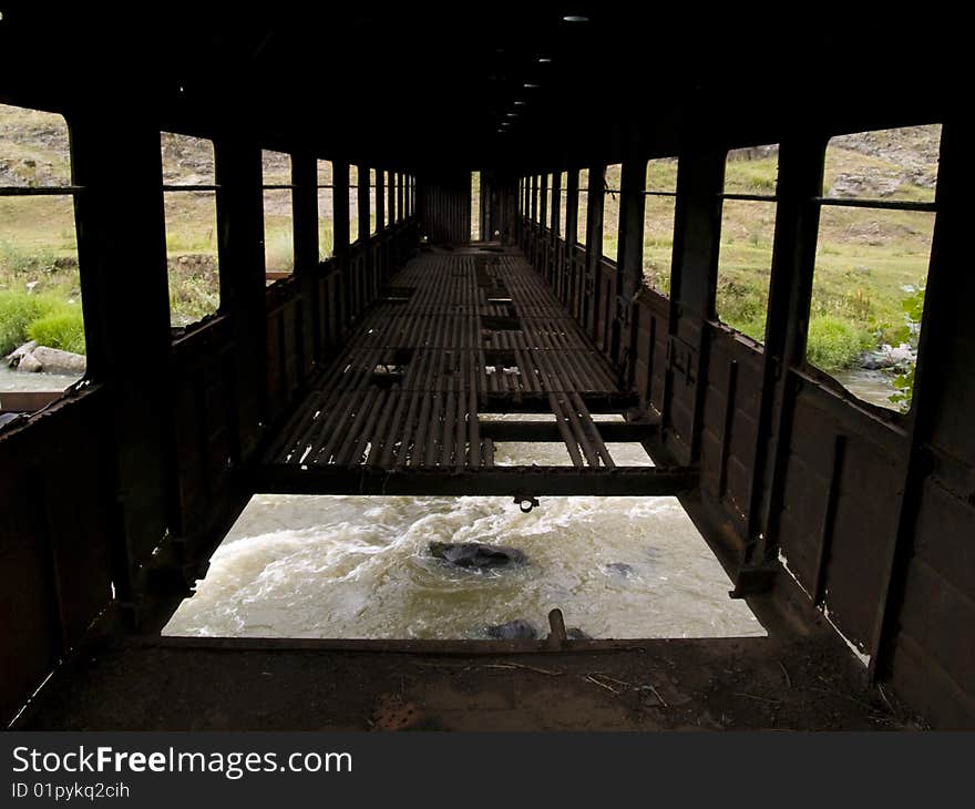 Big hole in the old bridge. In down rapid mountain river. Big hole in the old bridge. In down rapid mountain river