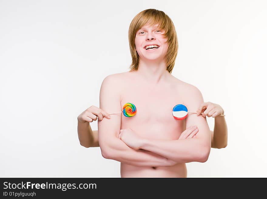 Smiling red-haired man with lollipops, isolated on white background