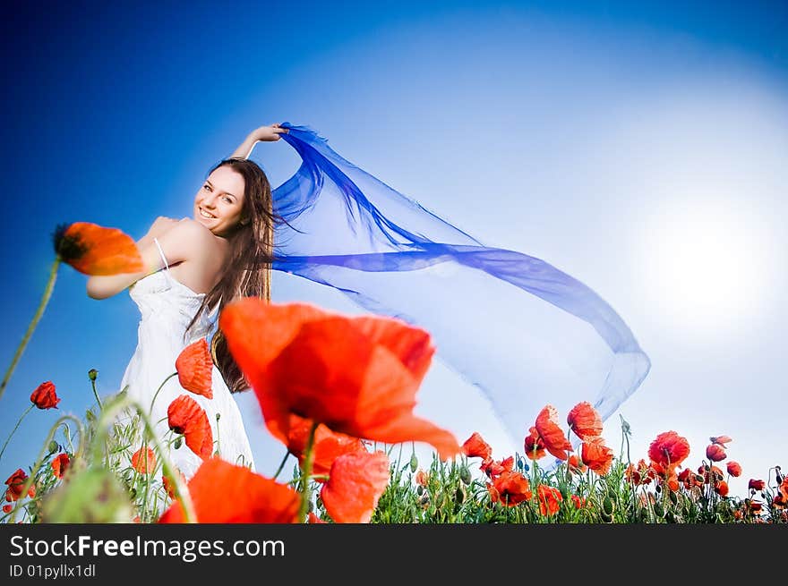 Beautiful girl in the poppy field