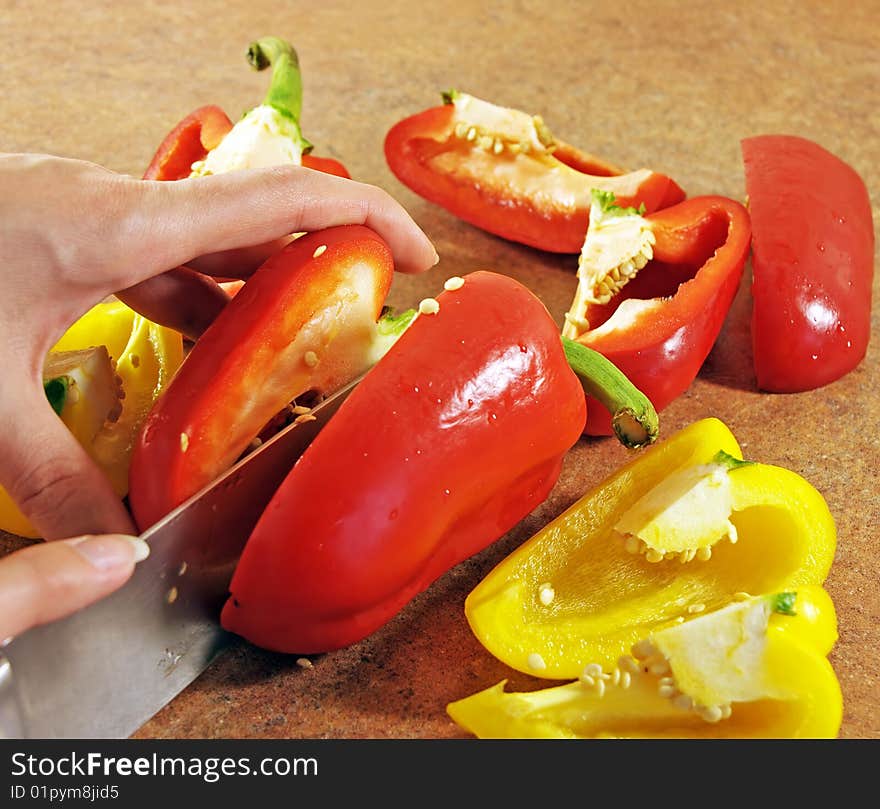 Female hands cut multi-coloured pepper. Female hands cut multi-coloured pepper