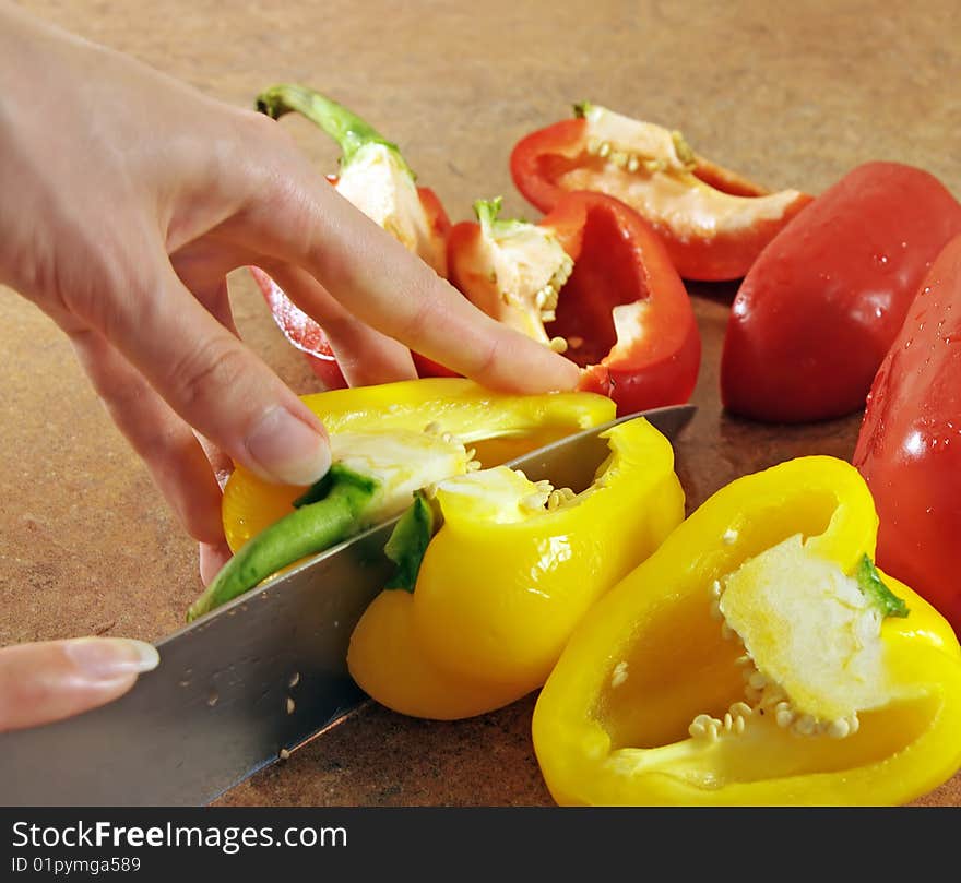 Female hands cut multi-coloured pepper. Female hands cut multi-coloured pepper