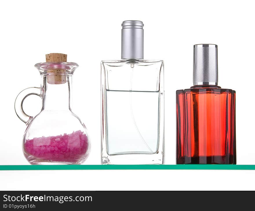 Perfume with decoration on a glass shelf. Perfume with decoration on a glass shelf