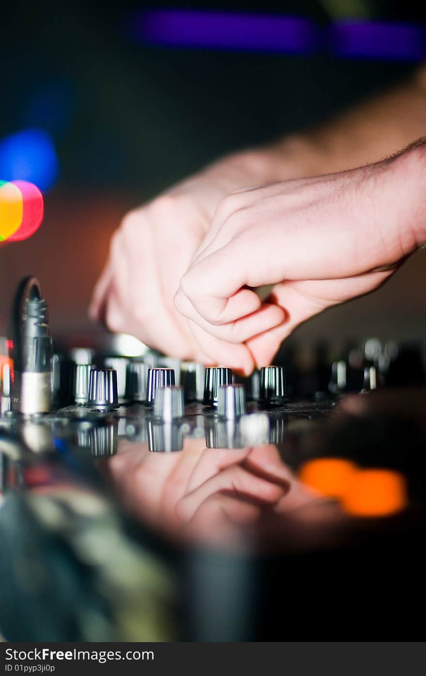 Close-up of deejays hand and turntable, soft focus