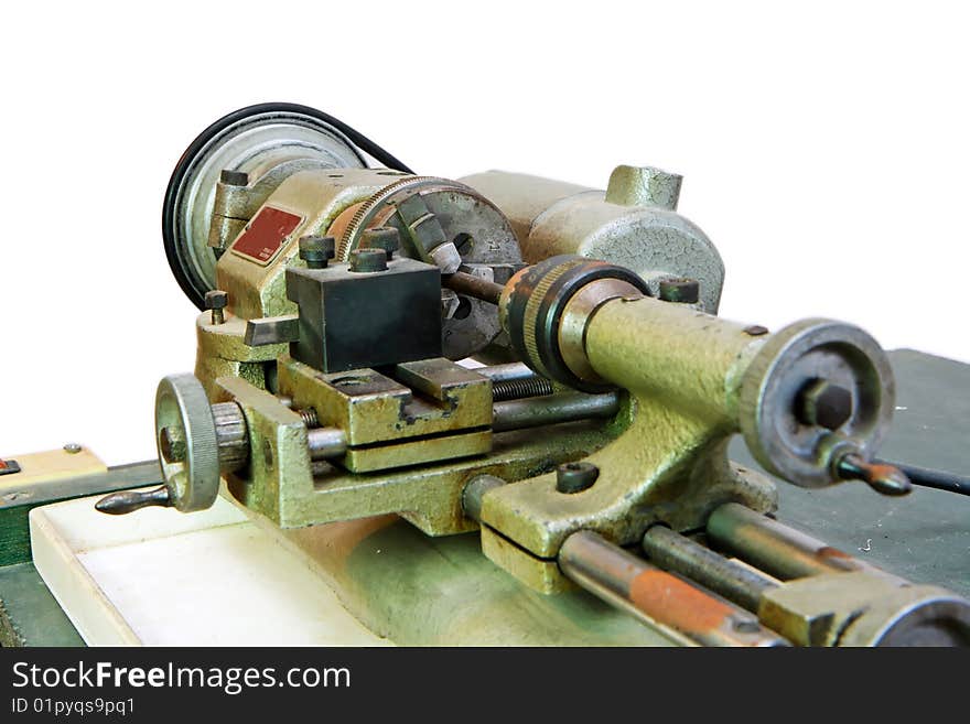 Small portable metal lathe closeup isolated. Small portable metal lathe closeup isolated