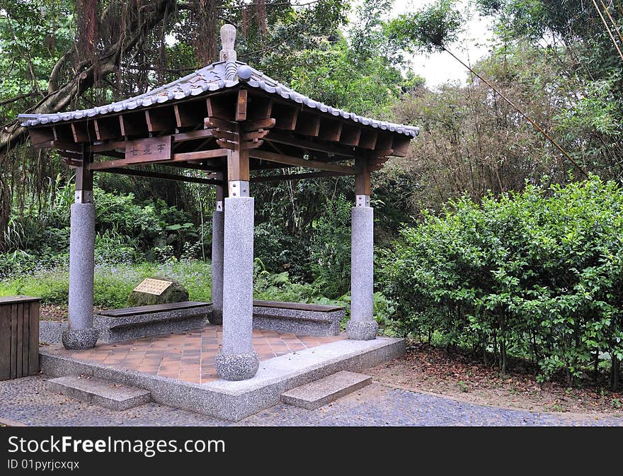 A square-shaped asian pavilion in the forest