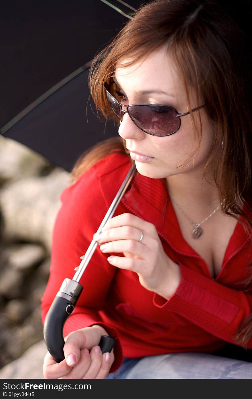 The young beautiful woman with a black umbrella. The young beautiful woman with a black umbrella