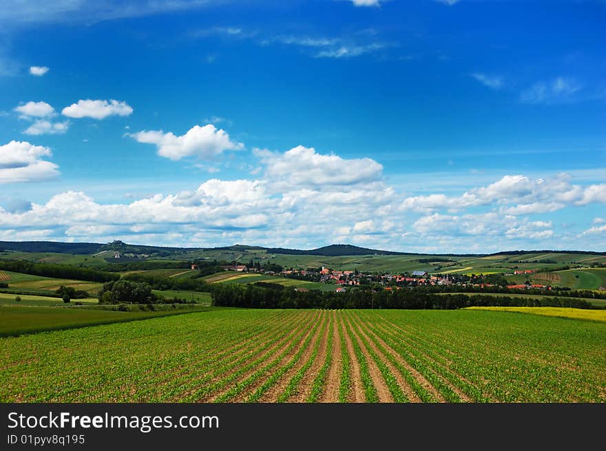 A scenic view of a cozy village among the hills