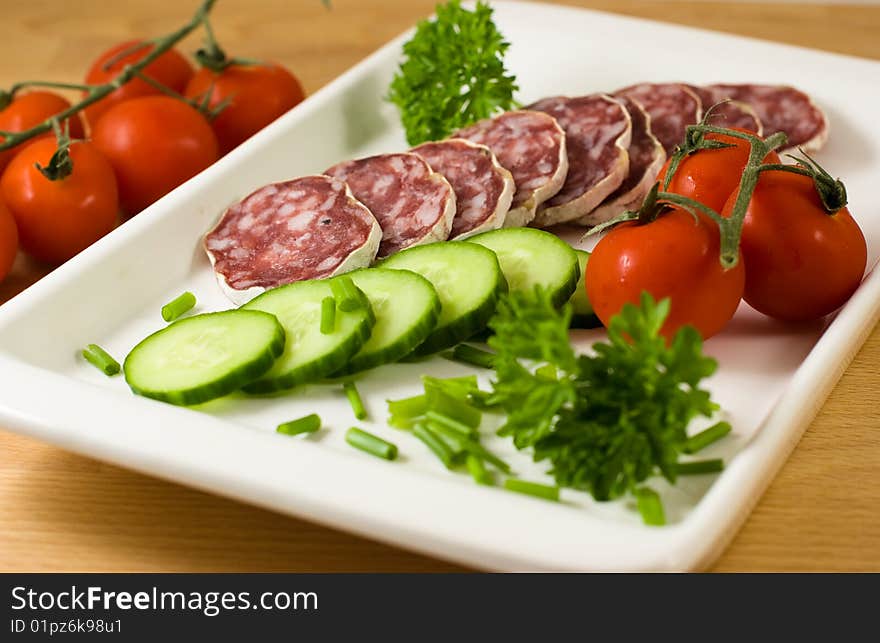 Salami with vegetables and herbs