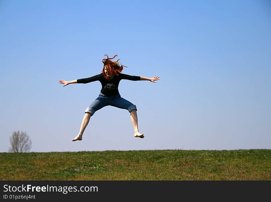 The girl taken in a jump like hanging in the air. The girl taken in a jump like hanging in the air