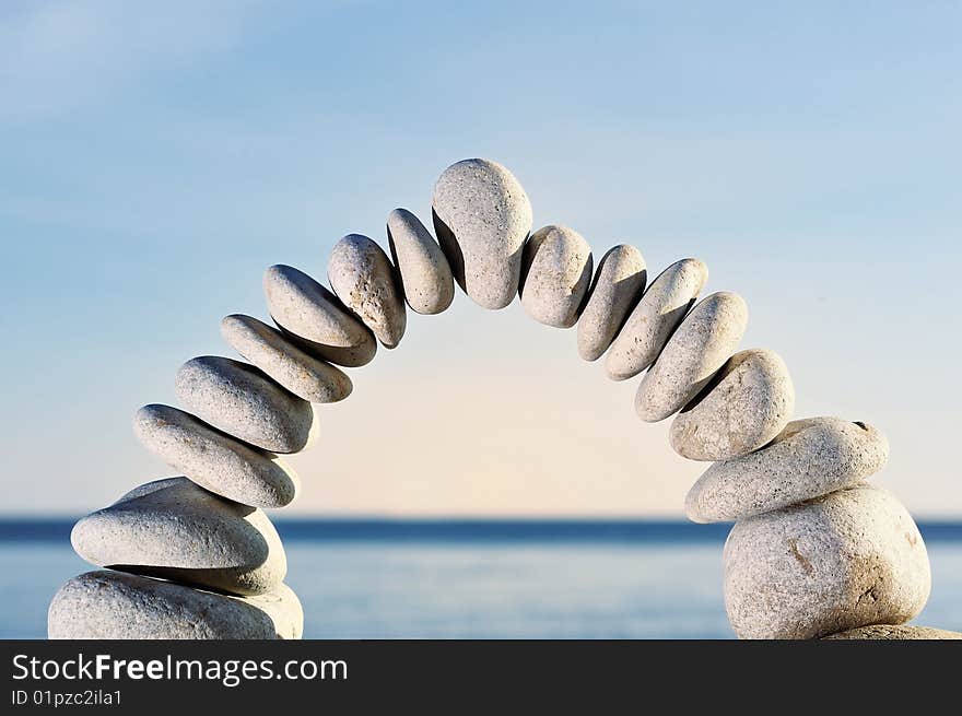 Large and small white pebbles in form an arc. Large and small white pebbles in form an arc