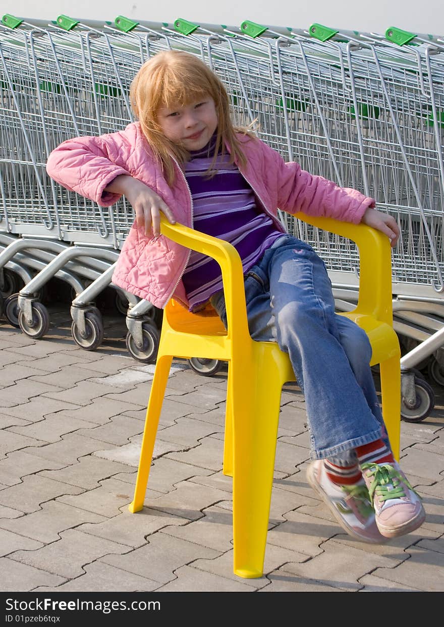 Girl on a plastic chair