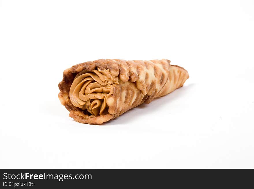 Wafer tubule, with a cream stuffing, on a white background