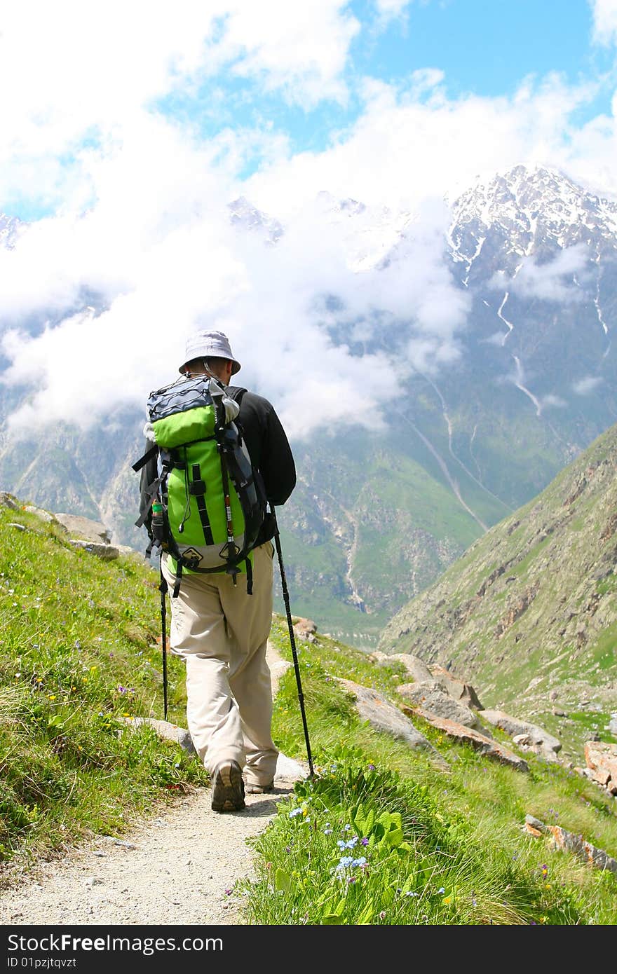 Hiker boy in Caucasus mountains