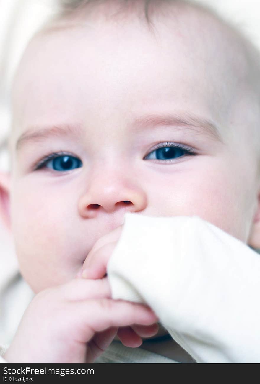 Portrait of a beautiful baby with his hands around your mouth