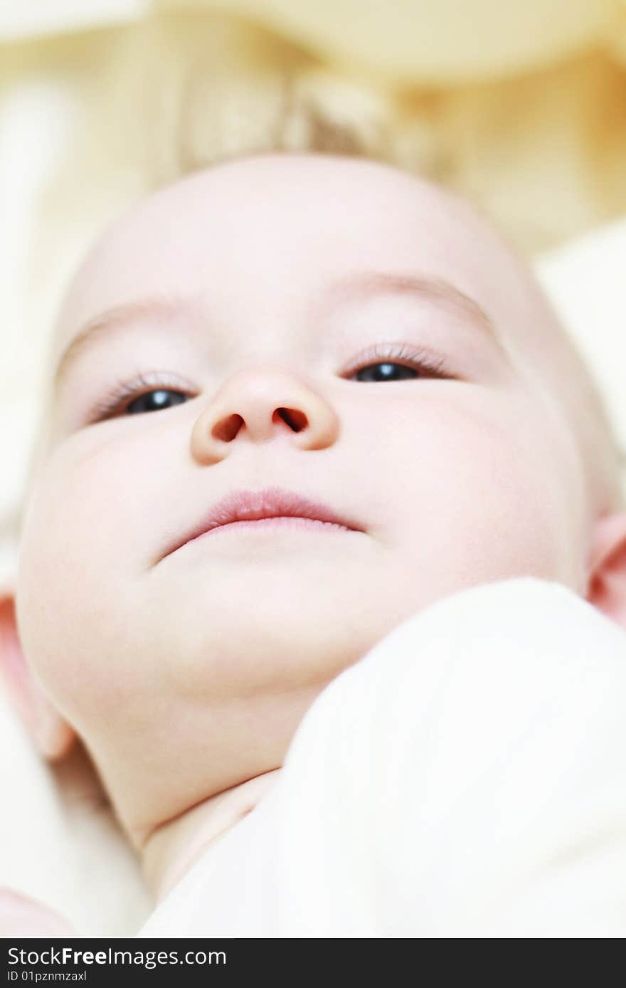 Portrait of a beautiful baby on a light background. Portrait of a beautiful baby on a light background