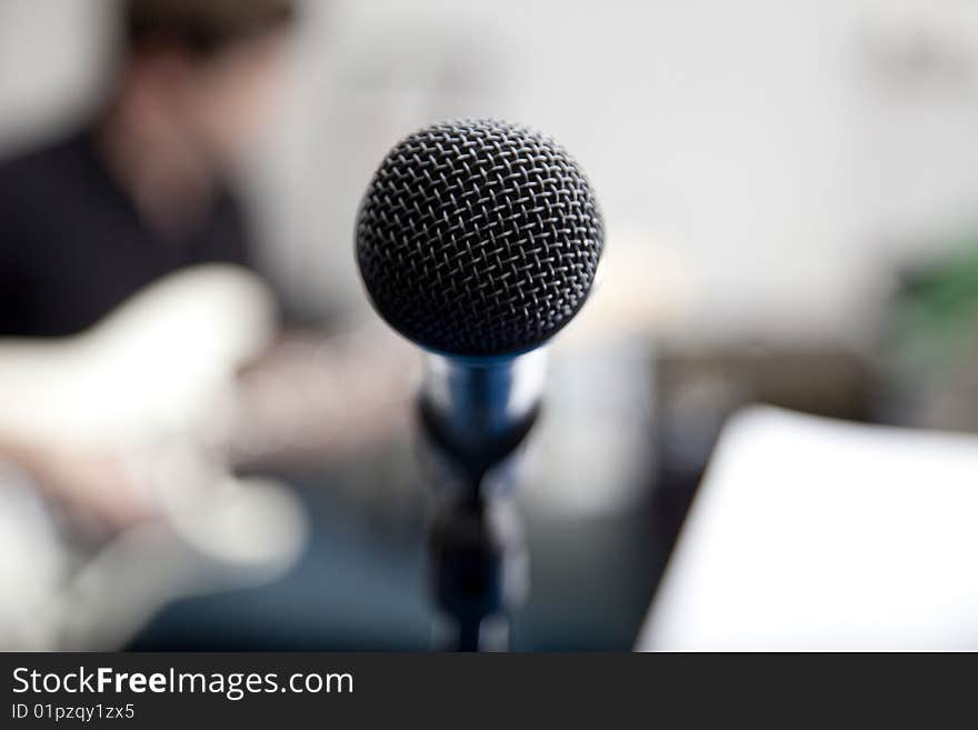 Microphone and guitar with blurred background