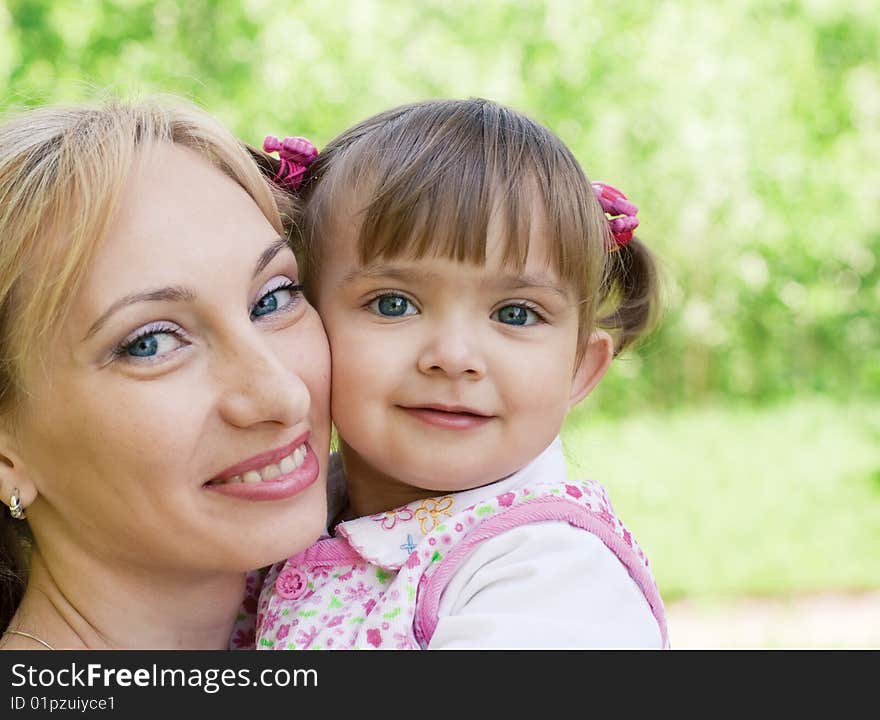 Happy mother and little daughter outdoor summer