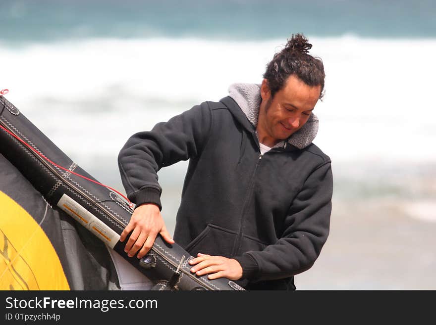 Man preparing kite on beach. Man preparing kite on beach