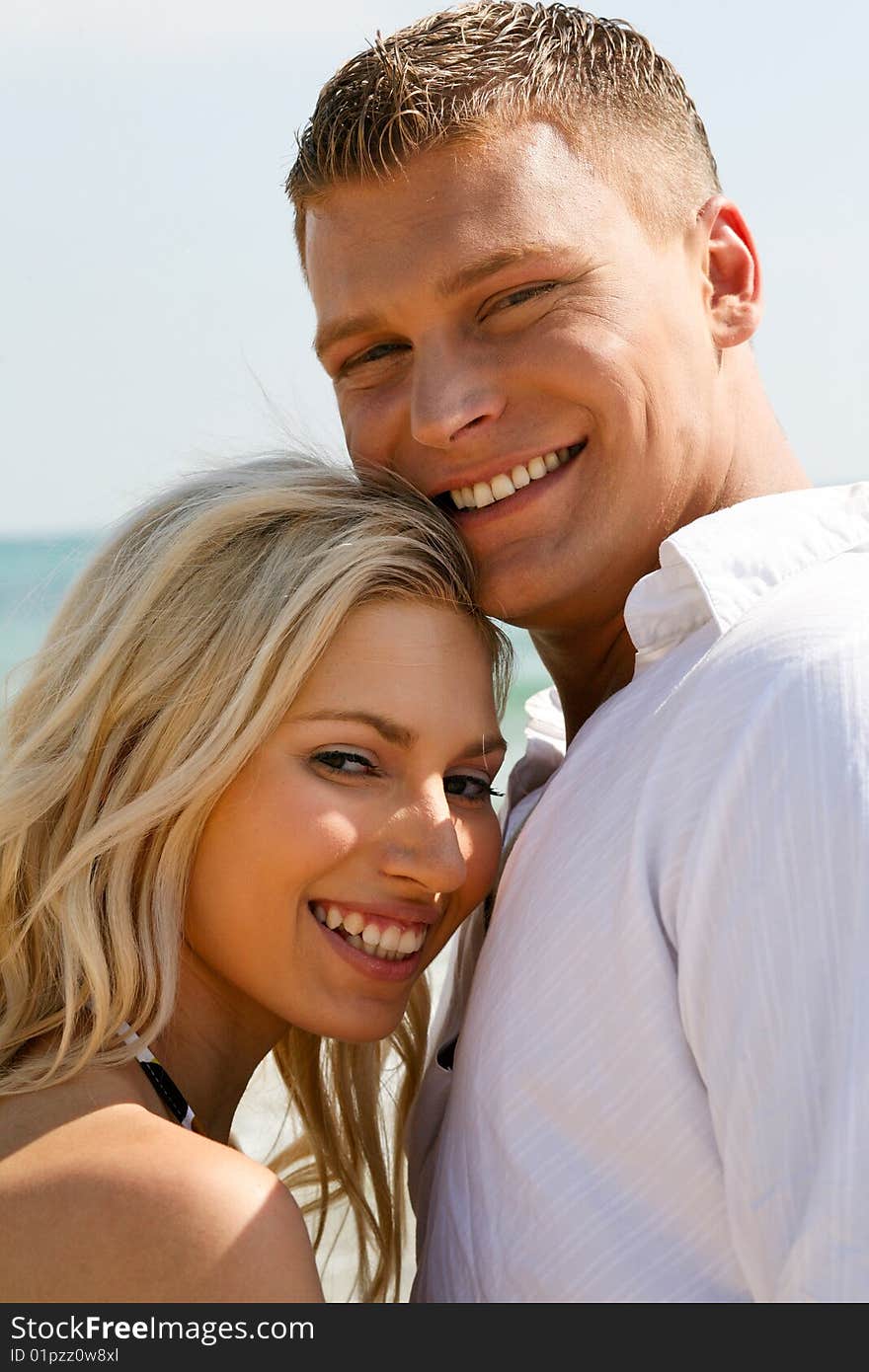 Juvenile couple full of joy near the beach