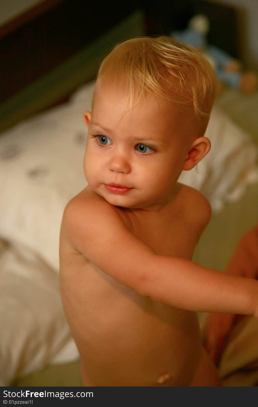 Baby standing up naked after the bath