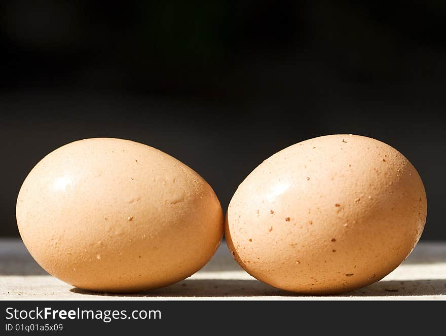 Close up of two eggs on a black background