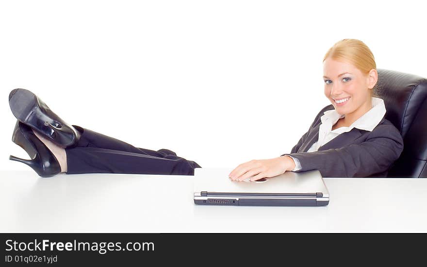 Businesswoman relaxing with legs on table.