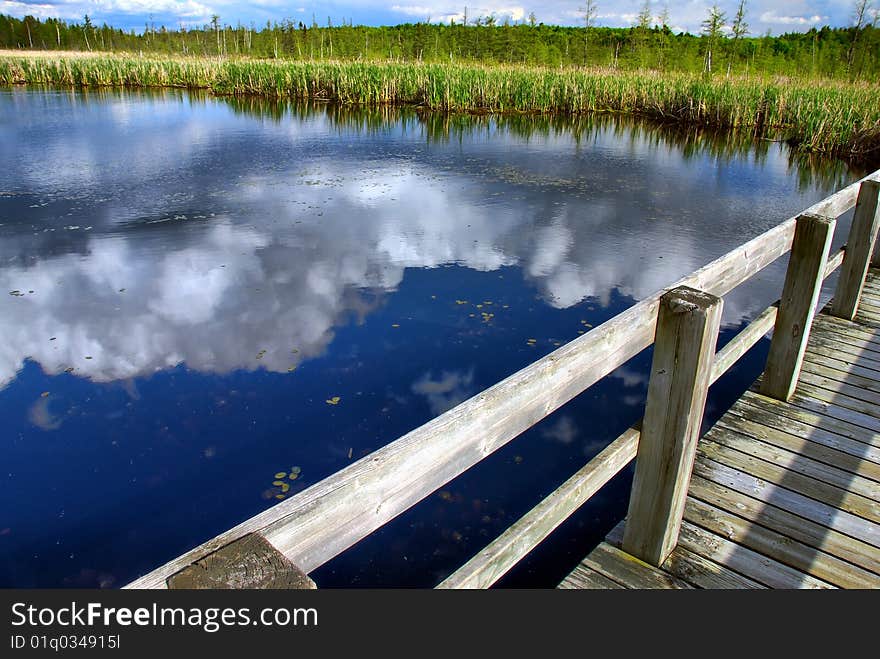 Boardwalk and Cloud Reflections