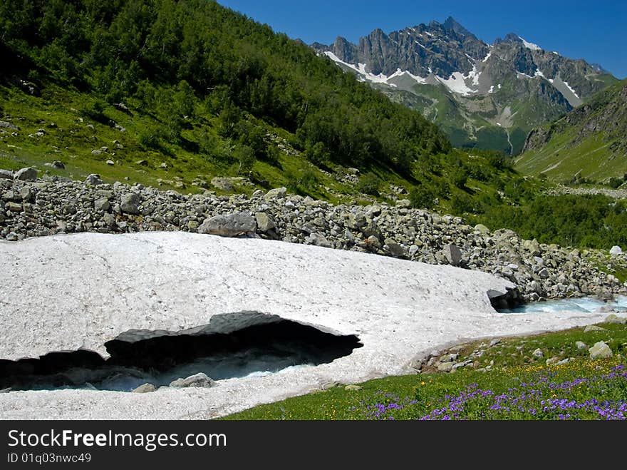 Glacier in the Caucasus, the forests, mountains far. Glacier in the Caucasus, the forests, mountains far