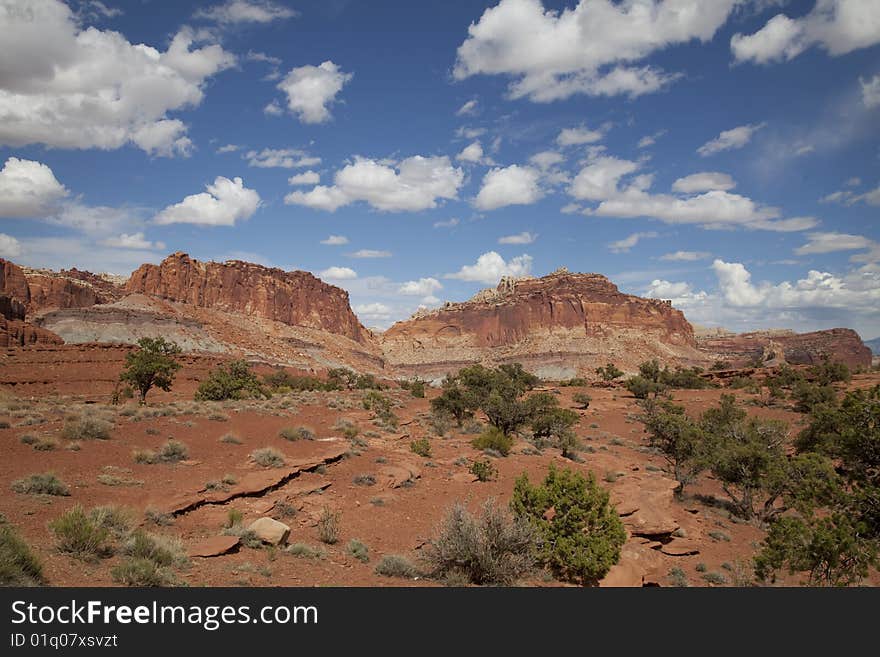 View of red rock formations in Captiol Reef National Park with blue sky�s the and clouds