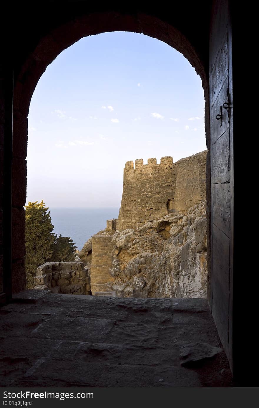 At rock top there is an ancient castle. This lock was constructed by knights, monks of Ionity.In the Middle Ages knights of Ionity owned island Rhodes. The city of Lindos. Island Rhodes. Greece. At rock top there is an ancient castle. This lock was constructed by knights, monks of Ionity.In the Middle Ages knights of Ionity owned island Rhodes. The city of Lindos. Island Rhodes. Greece.