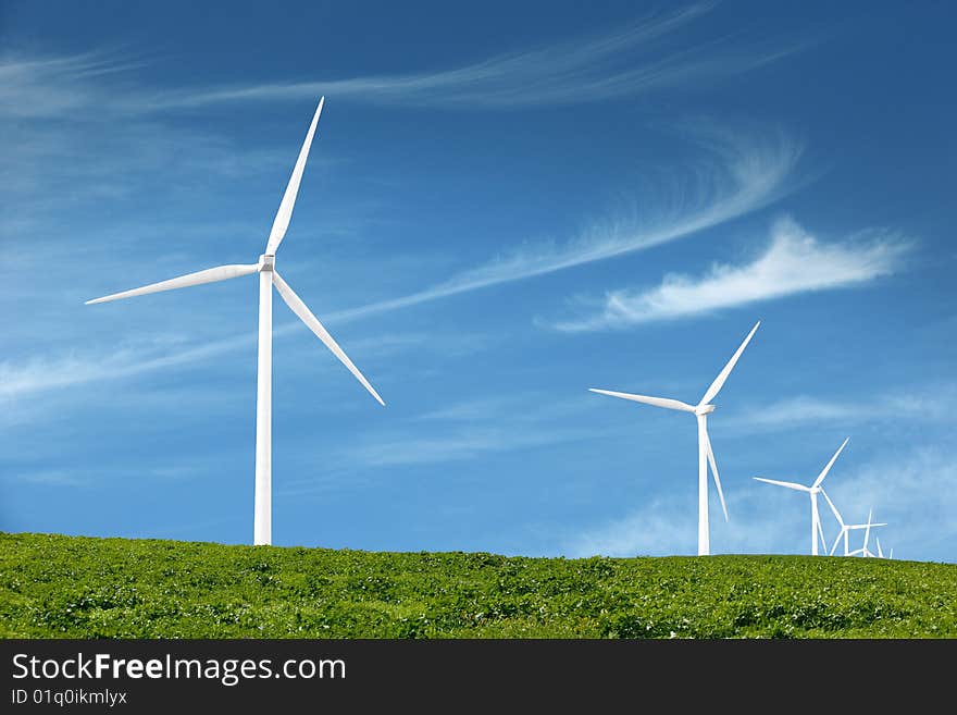 Wind turbines in an open field on cloudy day