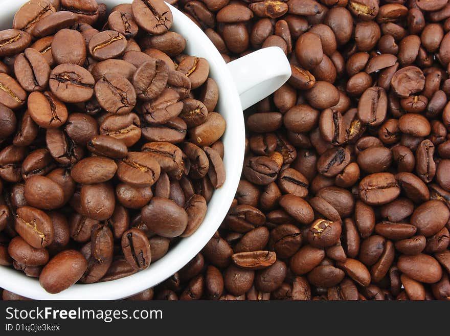 White Cup Filled With Coffee Beans