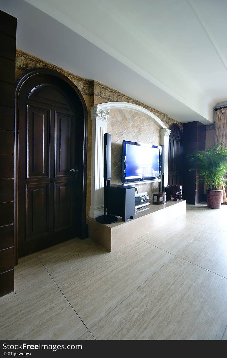 Media center in modern home with arched wooden door. Media center in modern home with arched wooden door.