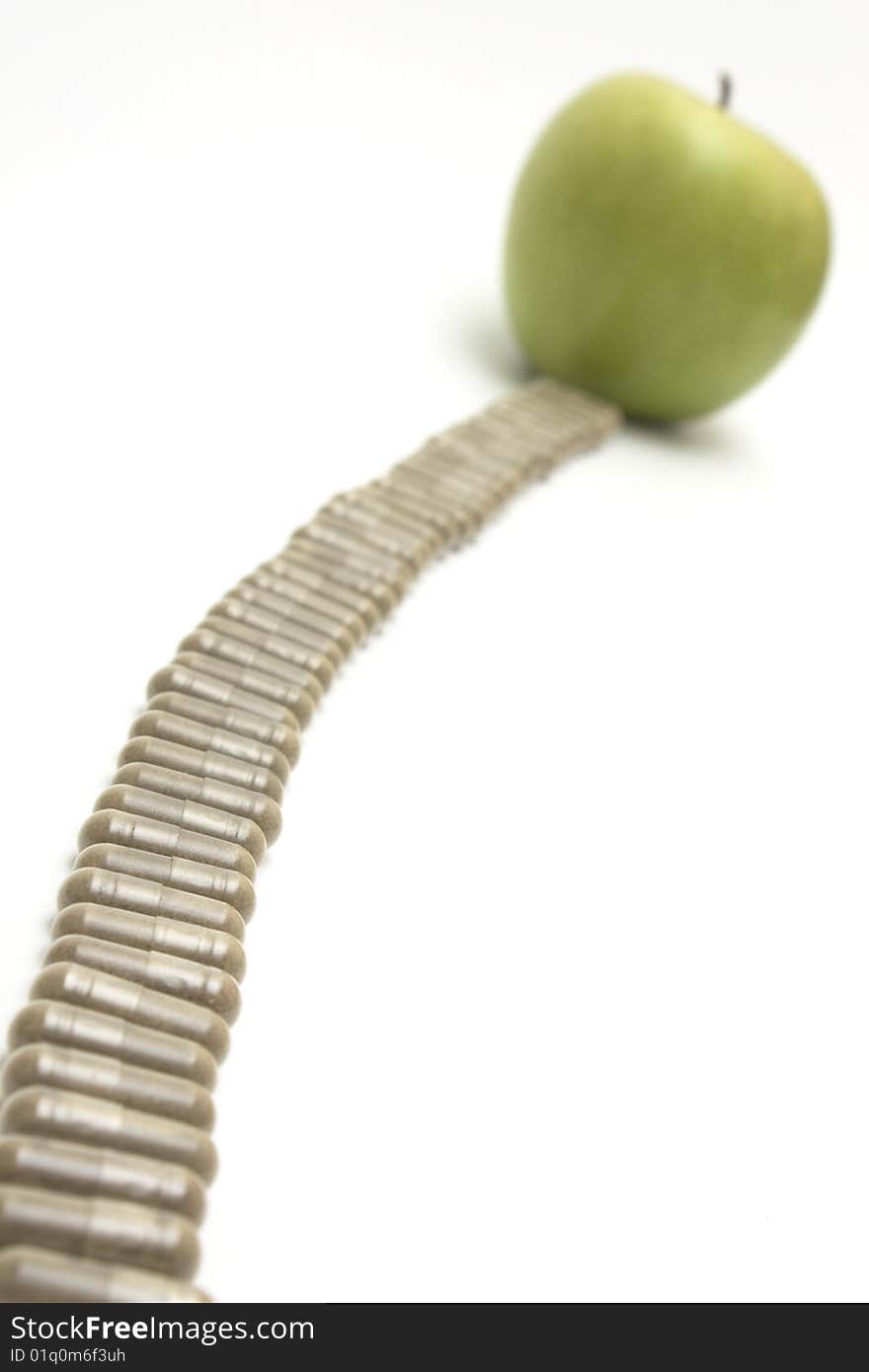 Apple and vitamin capsules on white background. Apple and vitamin capsules on white background