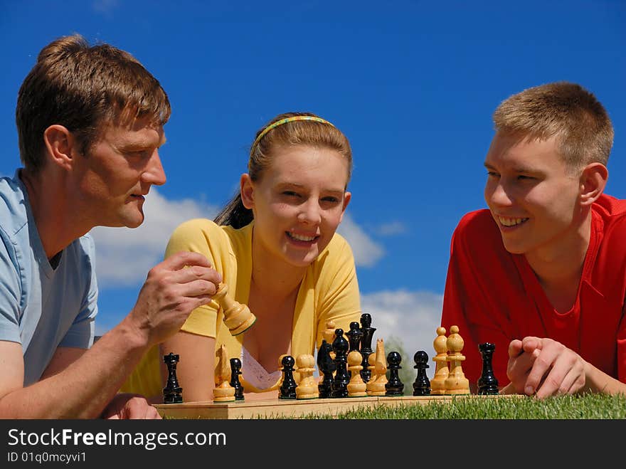 Father play chess with children