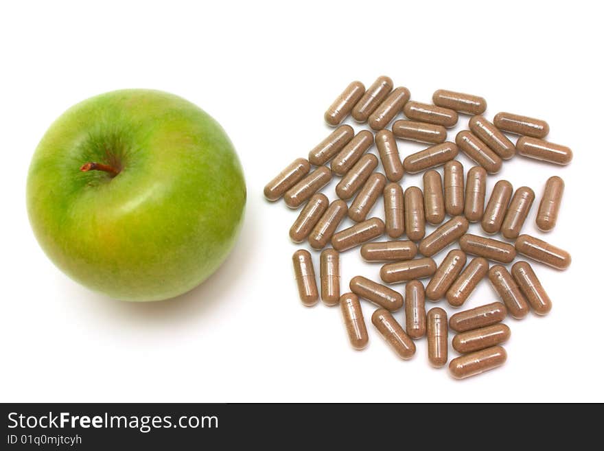 Apple and vitamin capsules on white background. Apple and vitamin capsules on white background