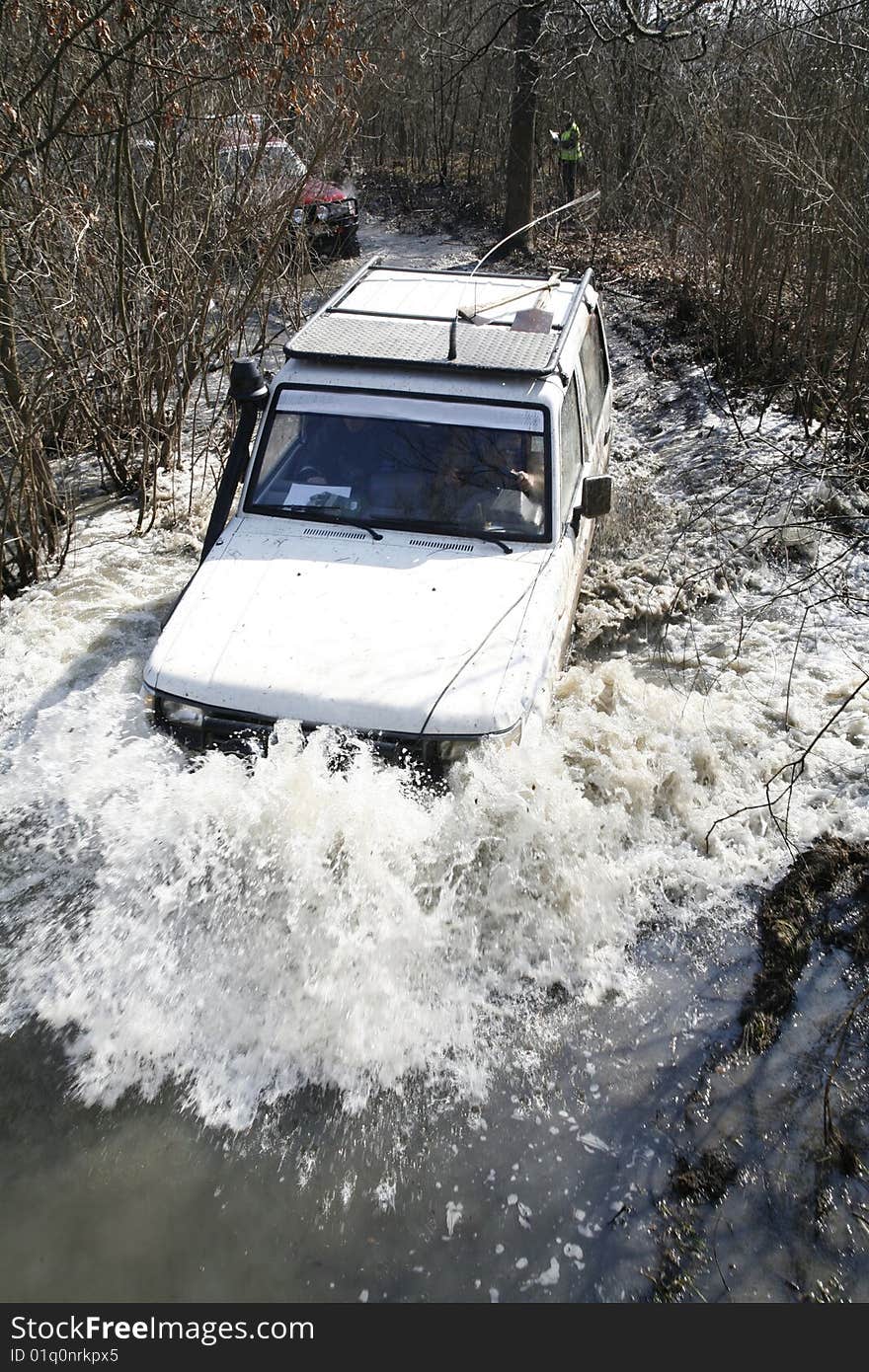 The white car goes on the big  river