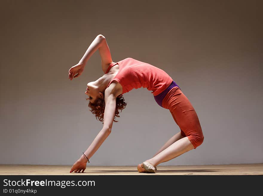 Modern style dancer posing on studio background. Modern style dancer posing on studio background